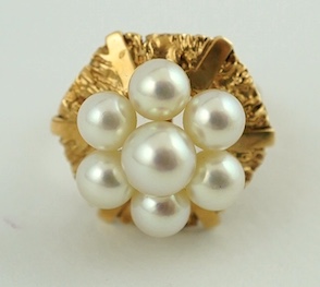 A 14K gold and cultured pearl dress ring, the hexagonal mount set with seven cultured pearls, size M, gross weight 7.6 grams. Condition - fair